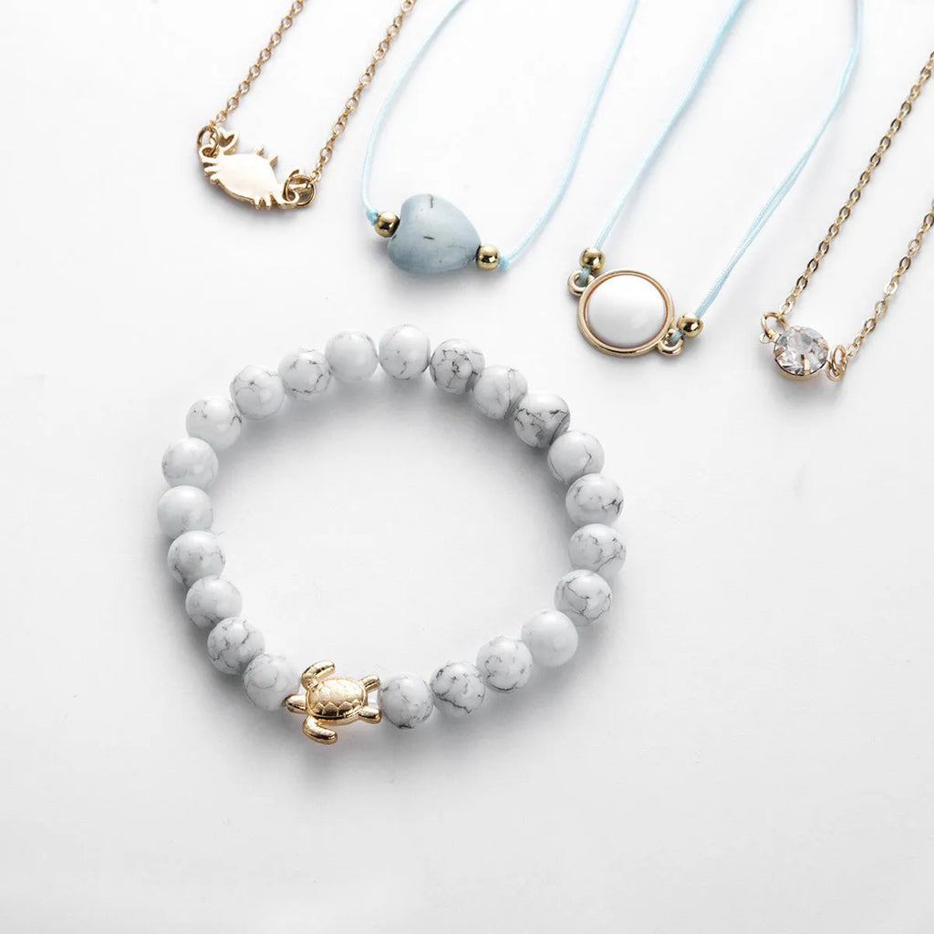 Turquoise crab bracelet in gold-tone electroplated alloy with 17cm chain and 5cm extension