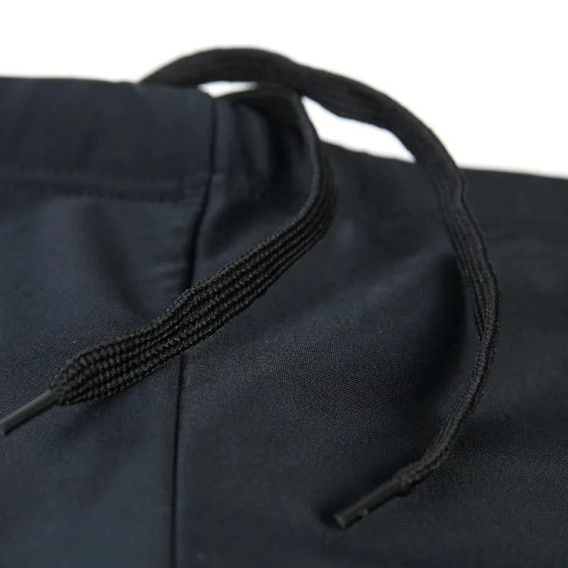 Men's patterned boxer swim trunks in plus sizes with optional swimming cap on a black background.