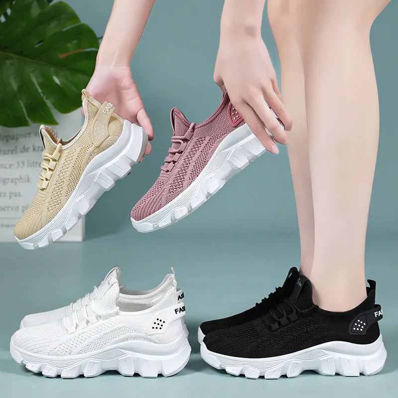 Women's white flyknit running sneaker with thick PVC sole and lace-up front