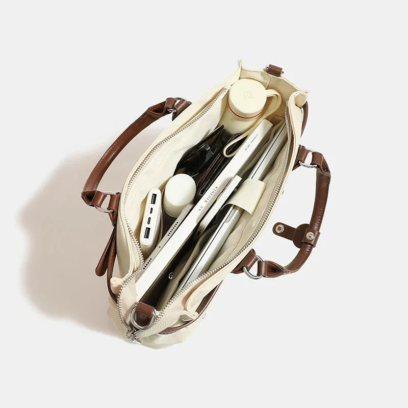Women's nylon shoulder tote bag in a horizontal square shape showing internal organiser pockets.