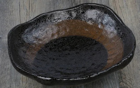 Japanese style irregular shaped ceramic sashimi bowl with floral decoration and matching sauce dish