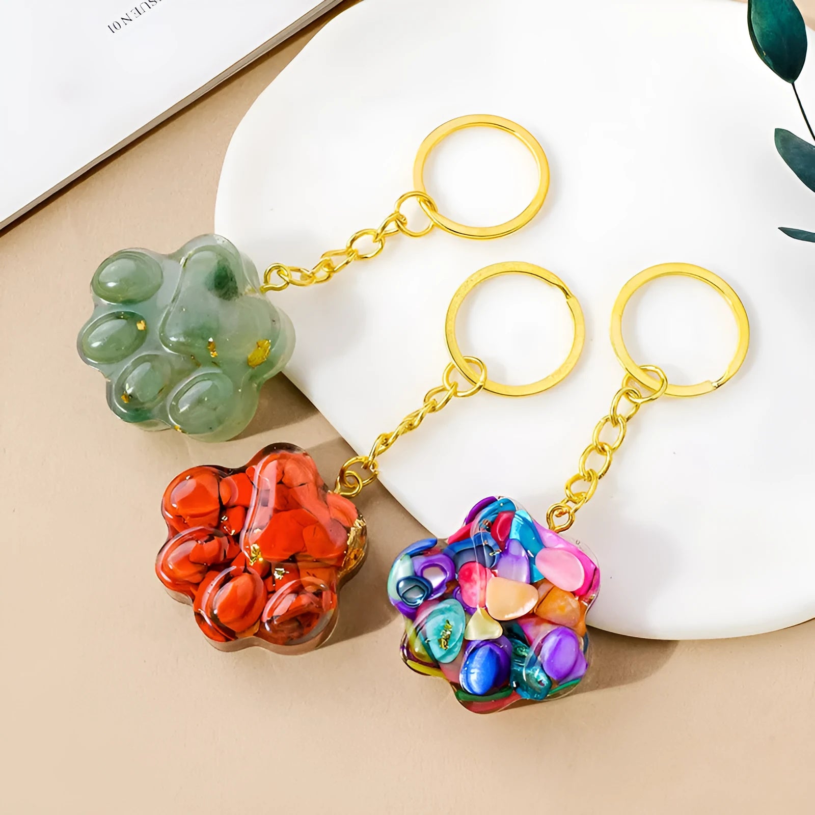 Cat's paw shaped keychain pendant made from a natural crystal gemstone on a keyring.