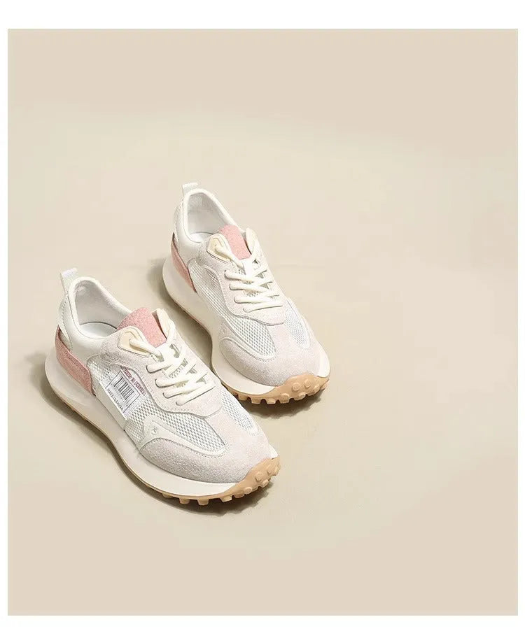 Women's gray retro sneaker with mesh lining and rubber sole on wooden floor