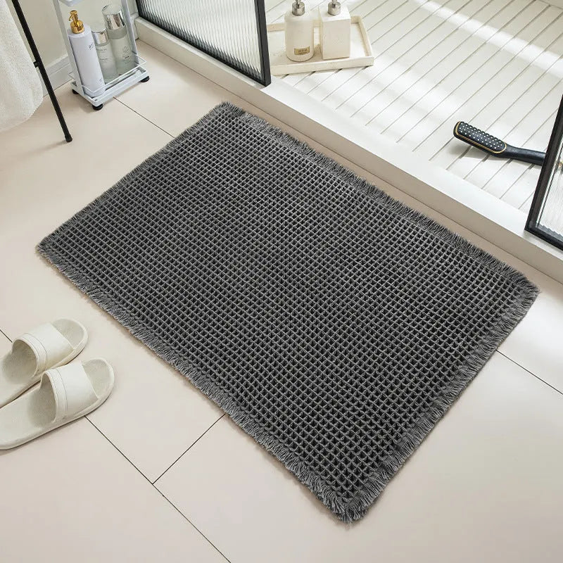 Checkered pattern non-slip absorbent bathroom carpet on a tiled floor.