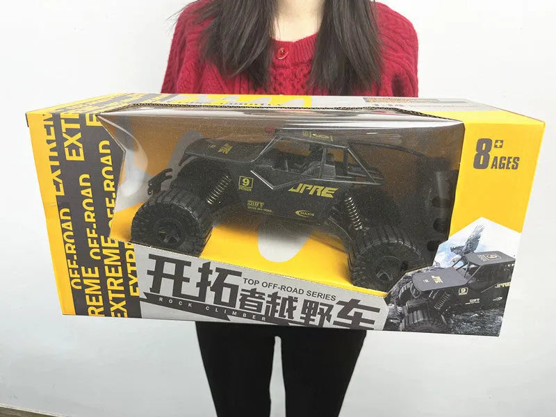 Super large black remote control off-road toy car with electric four-wheel drive and spring rod suspension