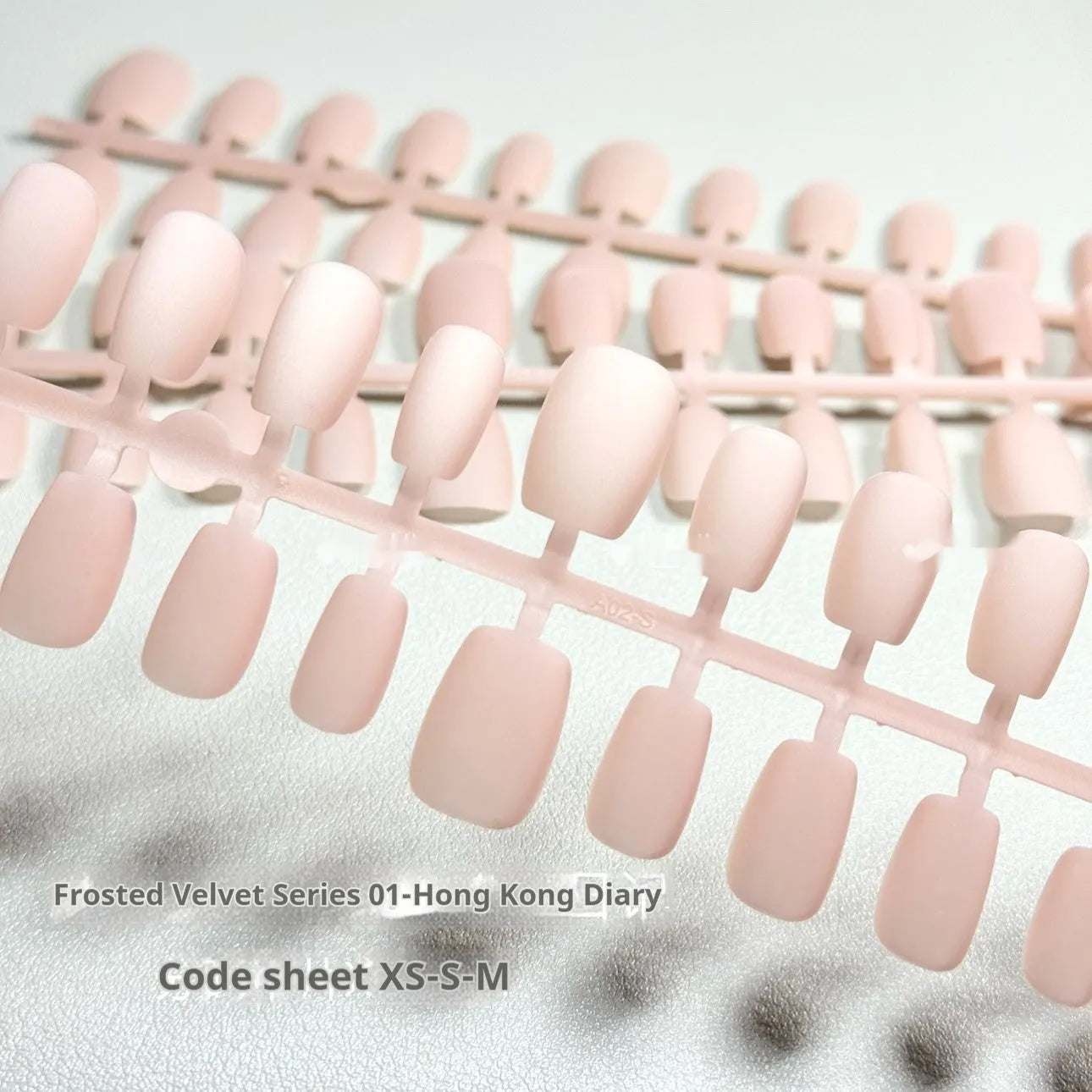 Set of frosted velvet Cat's Eye false nails with Aurora glitter on a clear background, showing short ladder sizes.
