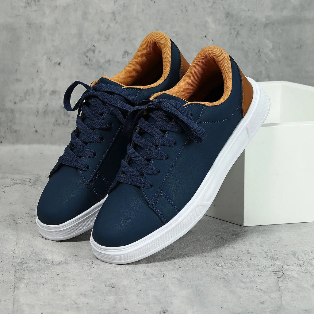 Beige brown platform casual skateboard sneaker with round toe and cross-strap detail on a white background.