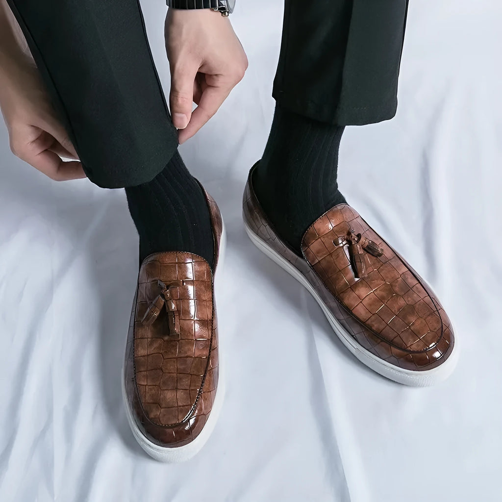Men's plus size black business casual sneakers with a tassel detail on the PU upper and a rubber sole.