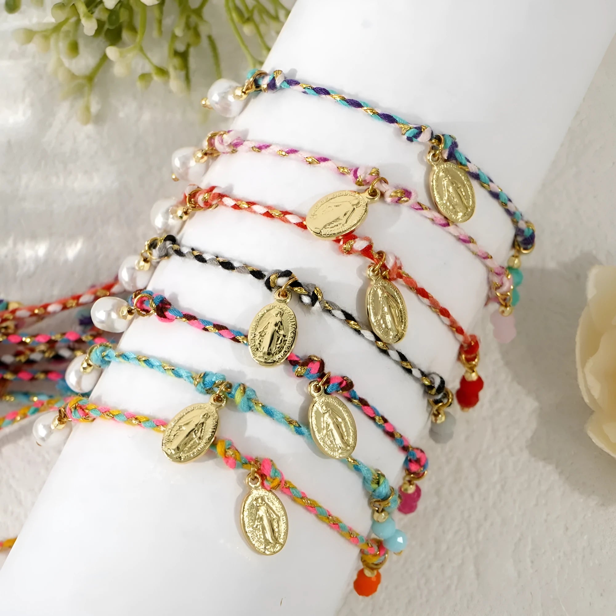 Close-up of a colourful hand-woven braided rope bracelet for women with an adjustable fabric strap tag.