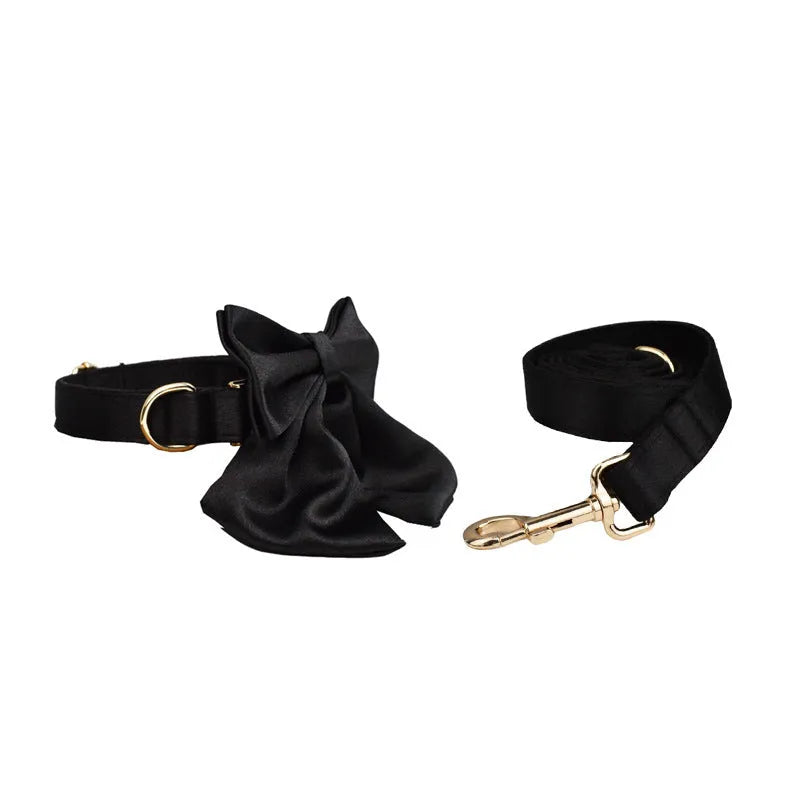 Cloth dog collar, leash, harness vest, and decorative bow set shown together in packaging.