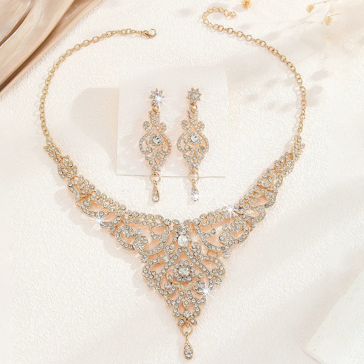 Hollow necklace and earrings set for women in gold or silver alloy with heart, water drop, or bell pattern