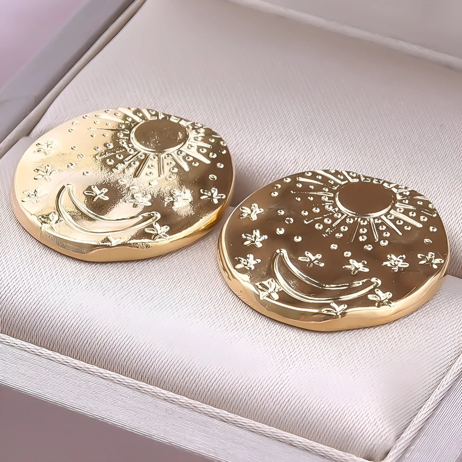 A pair of geometric shell design stud earrings in 304 stainless steel, shown in gold and silver finishes.