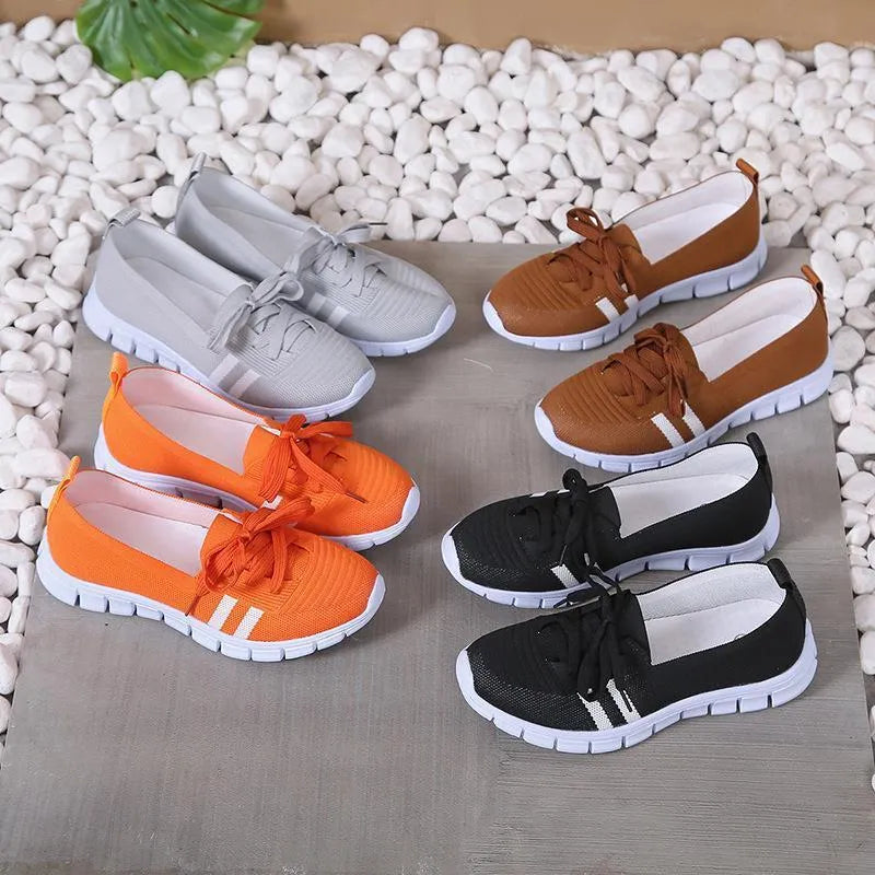 Women's lace-up mesh trainers with flat rubber sole, round toe and shallow mouth, shown in grey, black, orange and brown