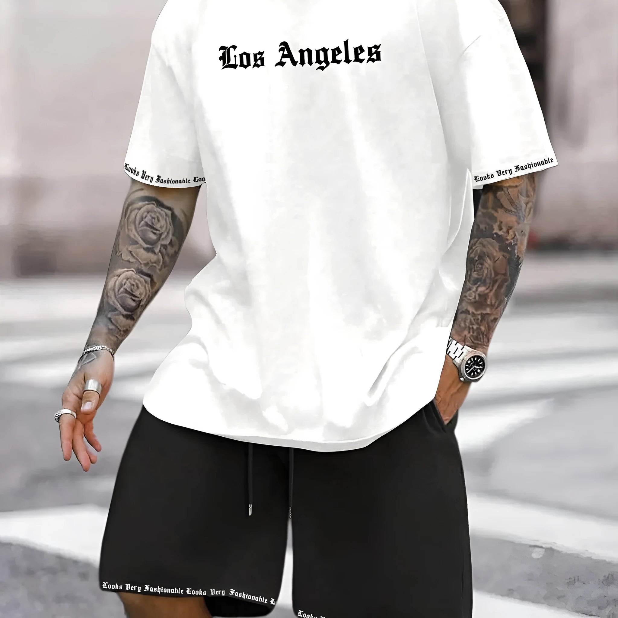 Man wearing a grey short sleeve athletic top and matching shorts from a polyester sportswear set.