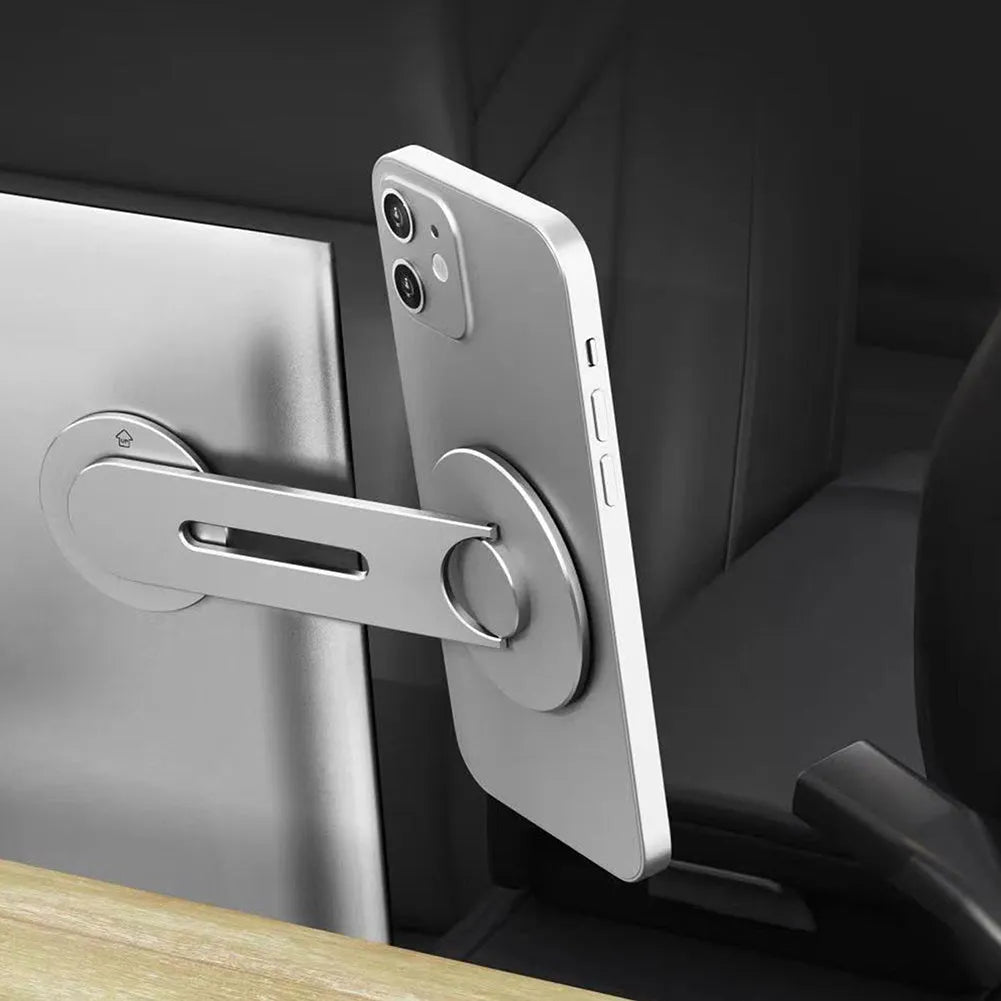 Silver CNC aluminum magnetic phone holder mounted on Tesla suspension screen showing 180 degree flip capability
