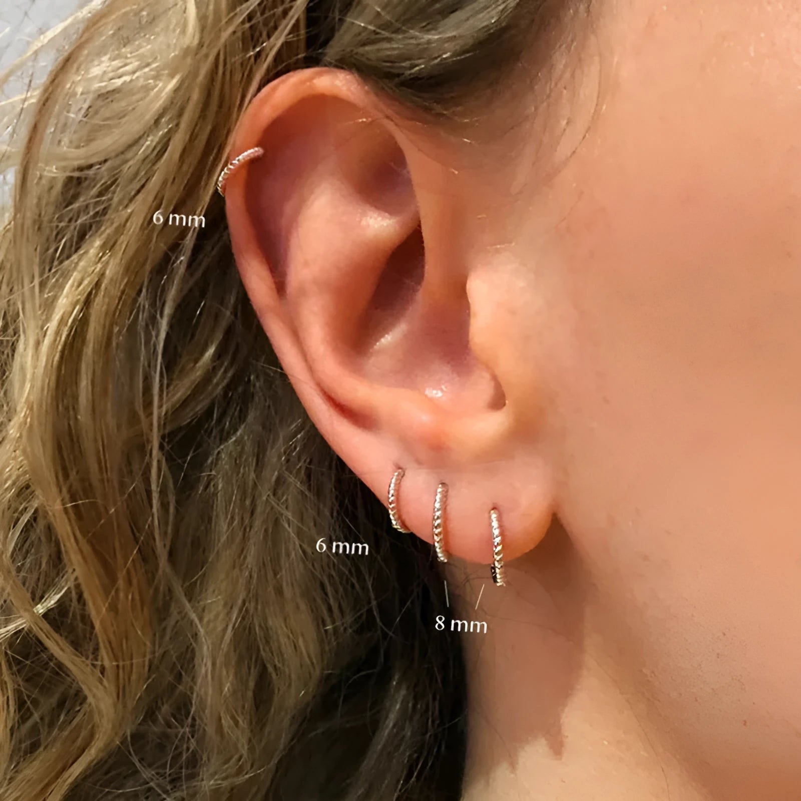 Twisted string round ring earrings in sterling silver with geometric design showing gold and platinum finish options