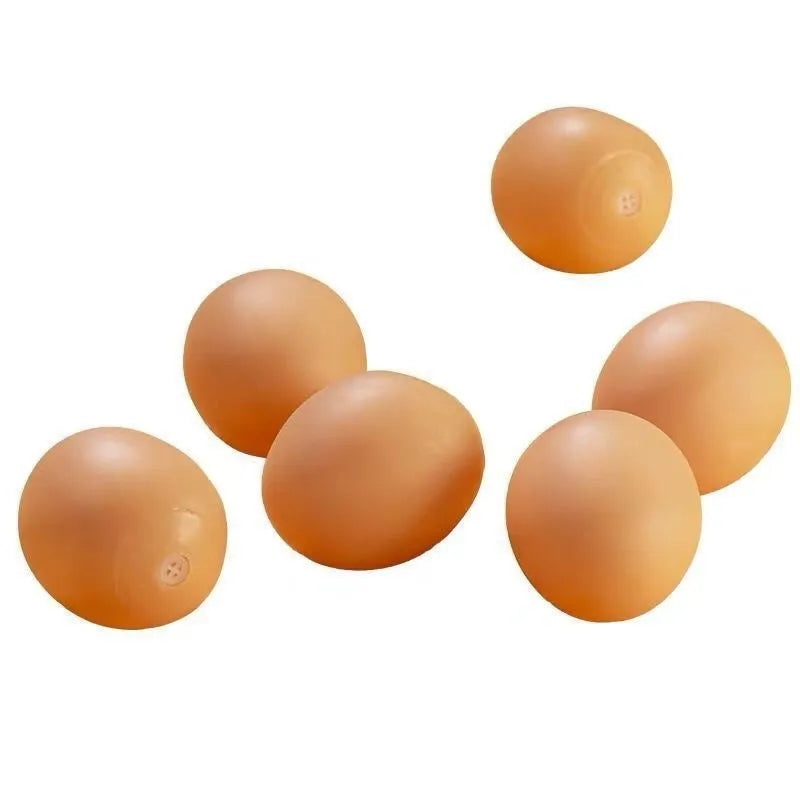 Red and white egg-shaped dog chew toy with textured surface and built-in squeaker