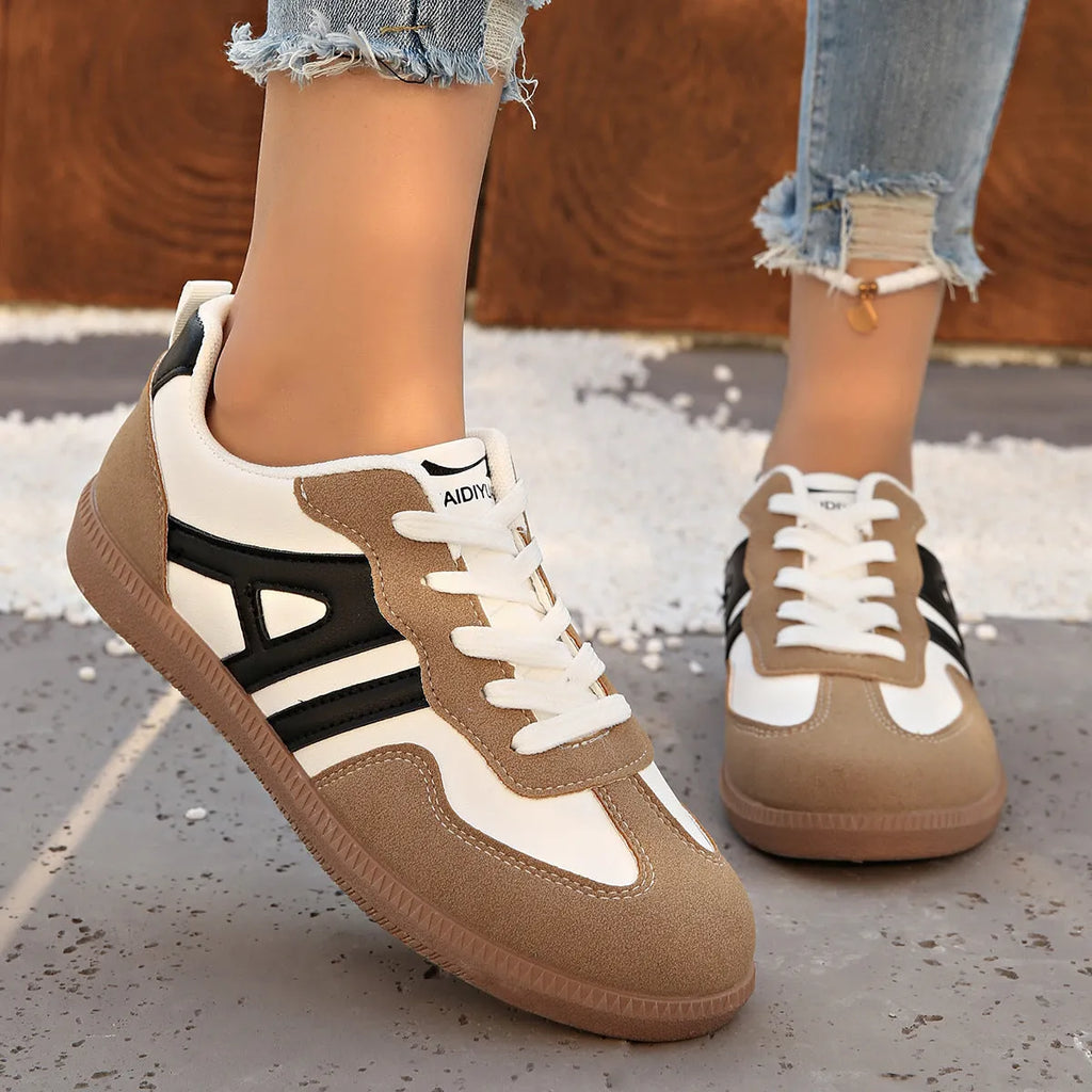 Women's retro colour matching lace-up jogging shoes in grey, showing cross-strap detail and platform sole.