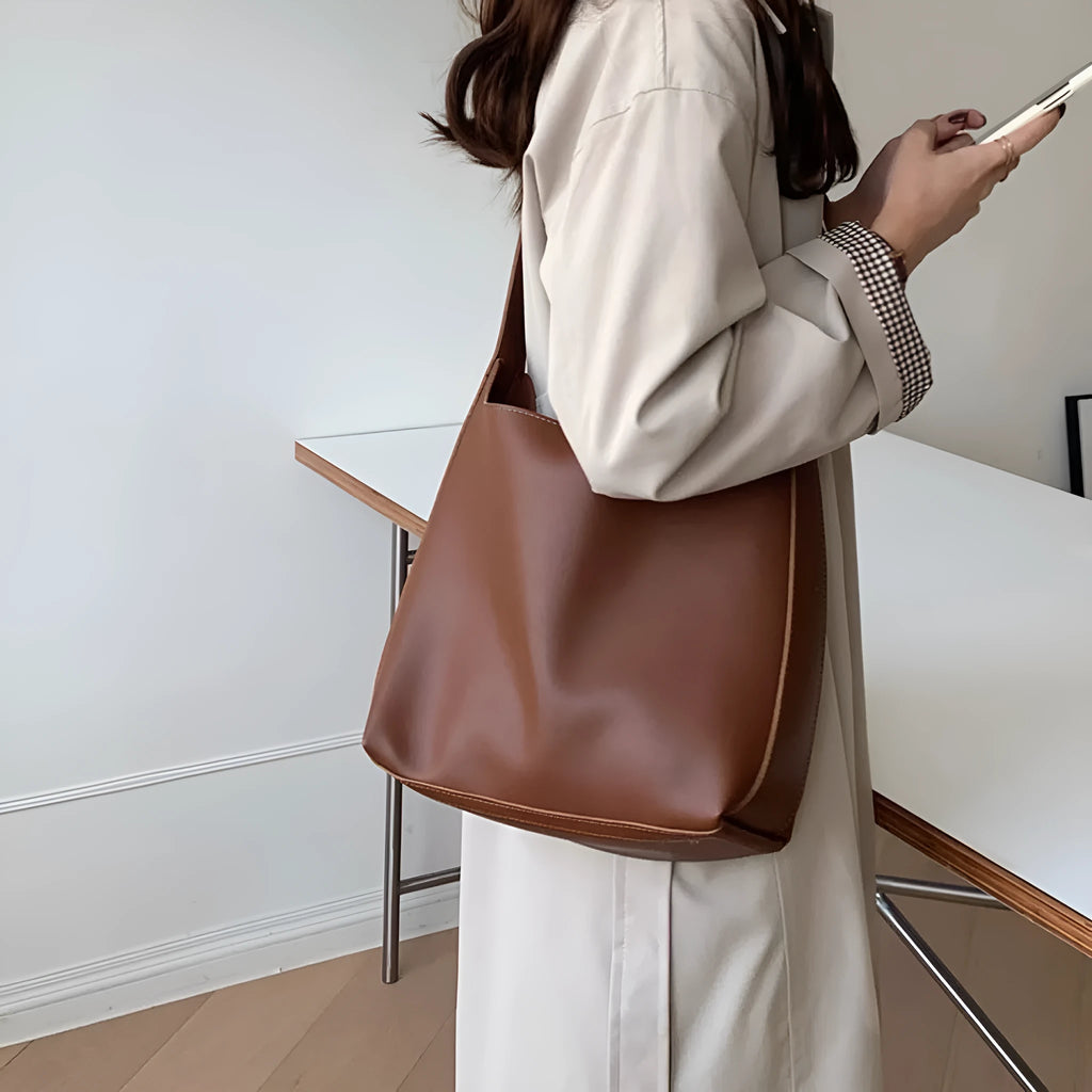 Women's soft PU shoulder bag with swing threads decoration in black and brown colour options