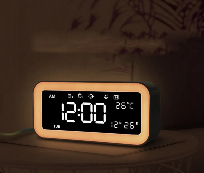 Blue rectangular LED atmosphere light and digital alarm clock on a table.