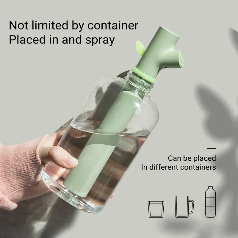 Transparent plastic USB-powered bottle humidifier with a decorative wooden branch diffuser.