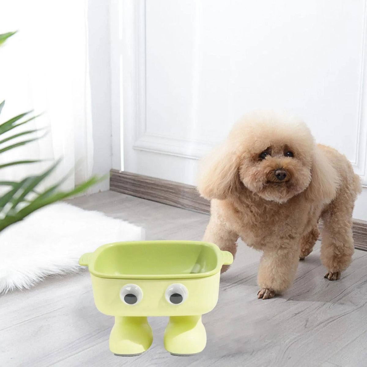 Green cartoon robot shaped elevated cat bowl with a tilted, detachable inner food dish.