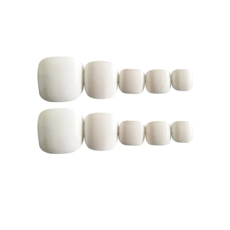 Set of white false nails with a starry sky pattern, shown with adhesive glue.