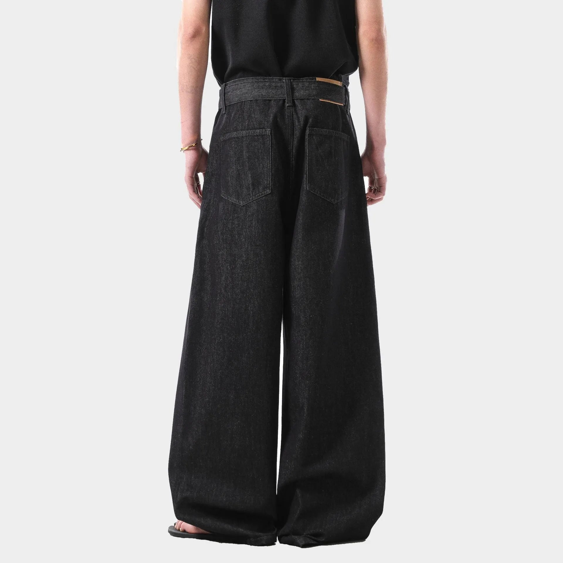 Black high waist straight leg jeans on a neutral background