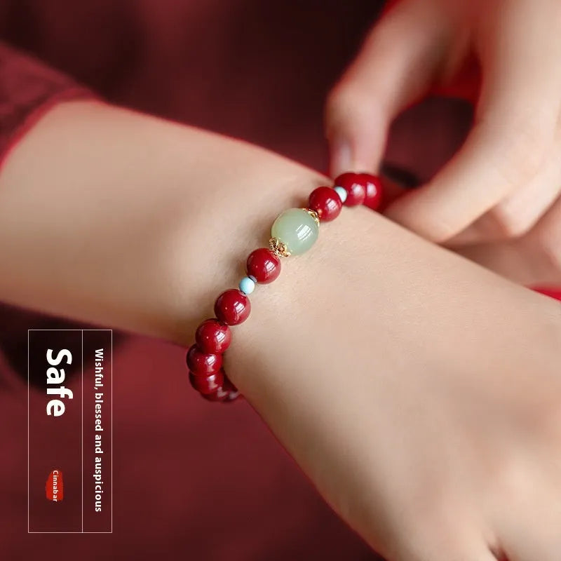 Purple gold sand cinnabar and Hetian jade beaded bracelet with geometric ellipse shapes on a wrist.