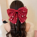 Pearl bow hair clip in black, red or beige with cloth, faux pearl and alloy construction