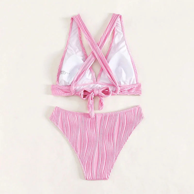 Women's black halter strap bikini with split shorts design on size chart background