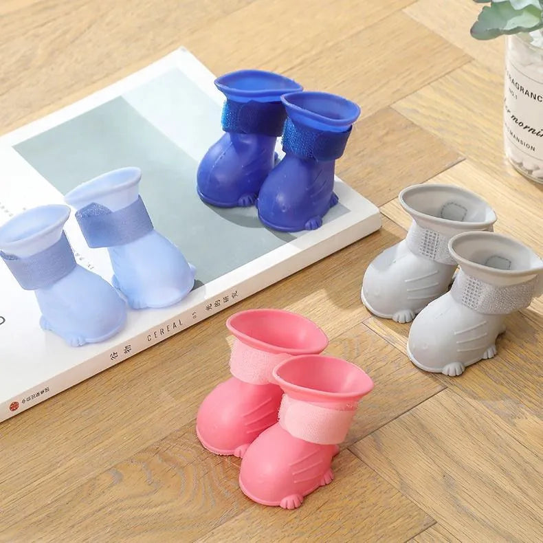 Set of four silicone dog rain boots in Dark Blue, Gray, Light Blue, and Pink, sizes S M L