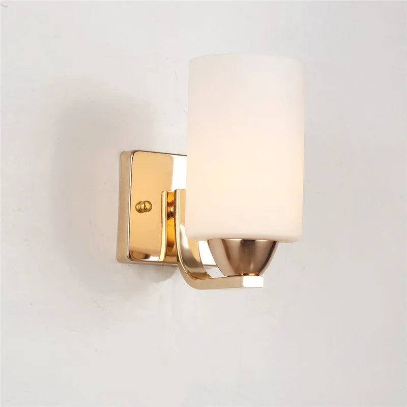 Chrome-finished wall lamp with glass shade in single head and double head configurations.