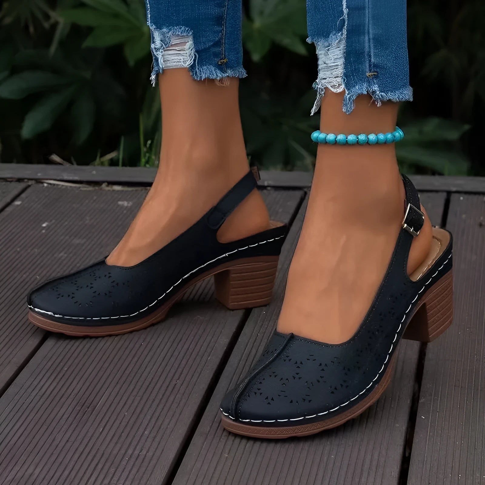 Women's closed toe wedge sandals in black colour showing round toe design and wedge heel