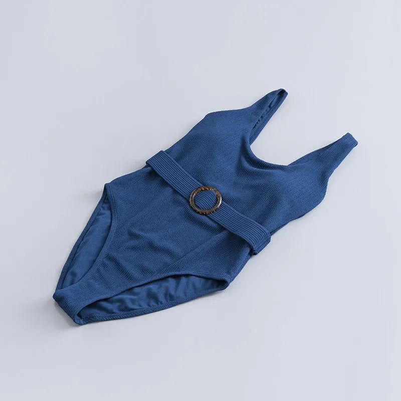 Navy blue women's one-piece triangle swimsuit on a hanger.