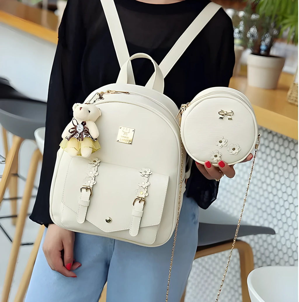 Women's floral PU leather three-piece bag set showing backpack, shoulder bag, and card purse.