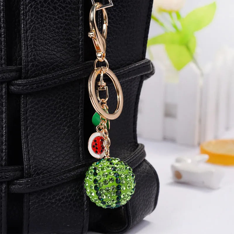 Green watermelon-shaped zinc alloy keychain measuring 12cm with fruit design details