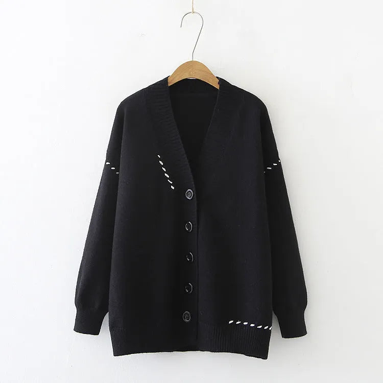 Women's loose fit knitted cardigan top coat in black or white colour with long sleeves.