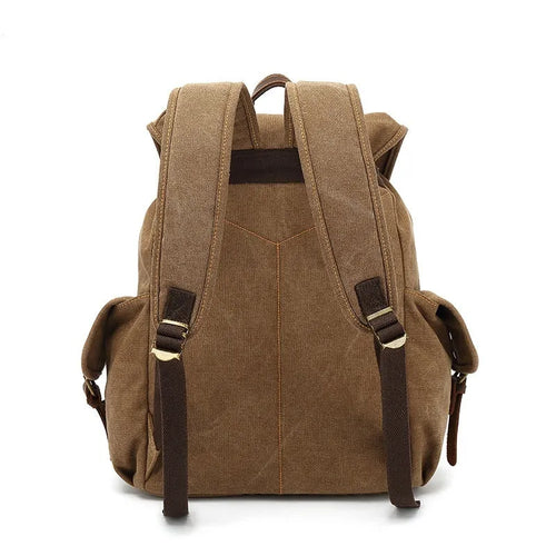 Retro-style canvas backpack in military green with antique bronze hardware, shown with a 16-inch laptop.