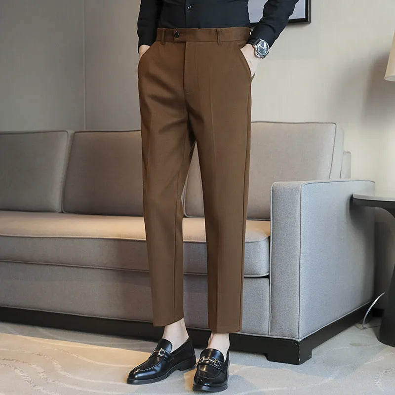 Brown straight leg corduroy trousers for men laid flat, showing slim fit and elastic waistband detail.