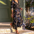 V-neck chiffon dress with printed pattern and A-line skirt on a hanger.