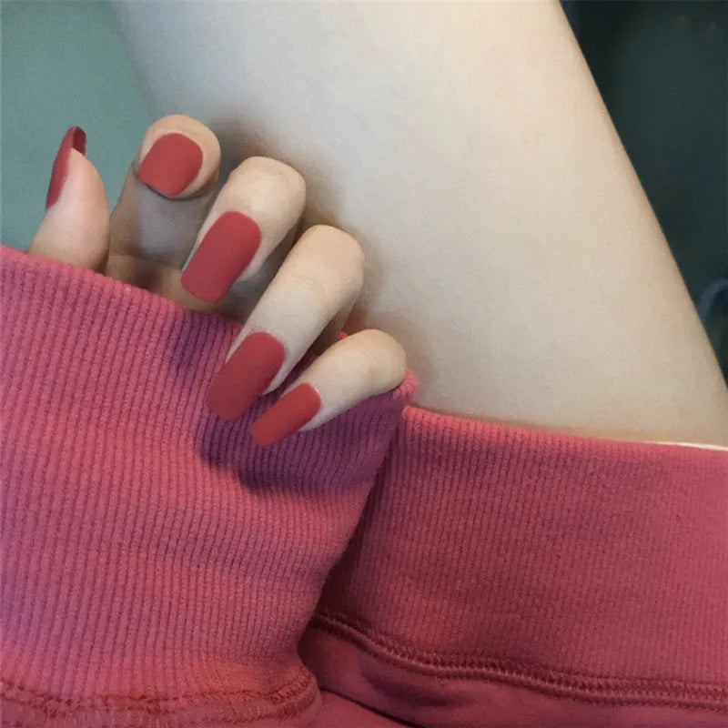 24-piece matte red medium length false nail set with glue-on application, approximately 27g net content