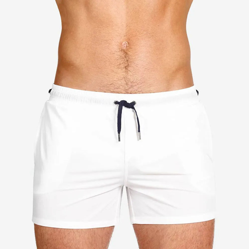Man's solid colour polyester swimming shorts with mesh lining for sports and fitness.
