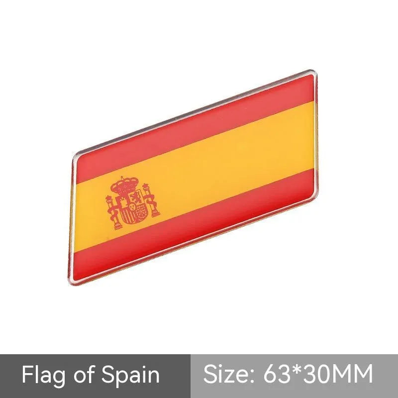 Aluminium national flag car sticker in a parallelogram shape measuring 6.3 by 3 centimetres.