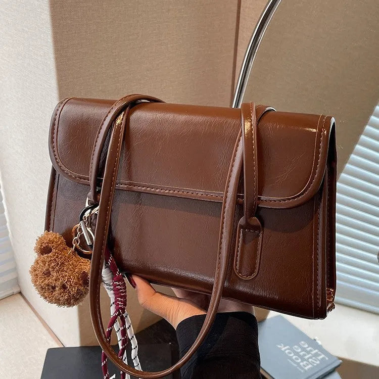 Women's brown PU Maillard shoulder bag with pendant showing horizontal square shape and dual straps