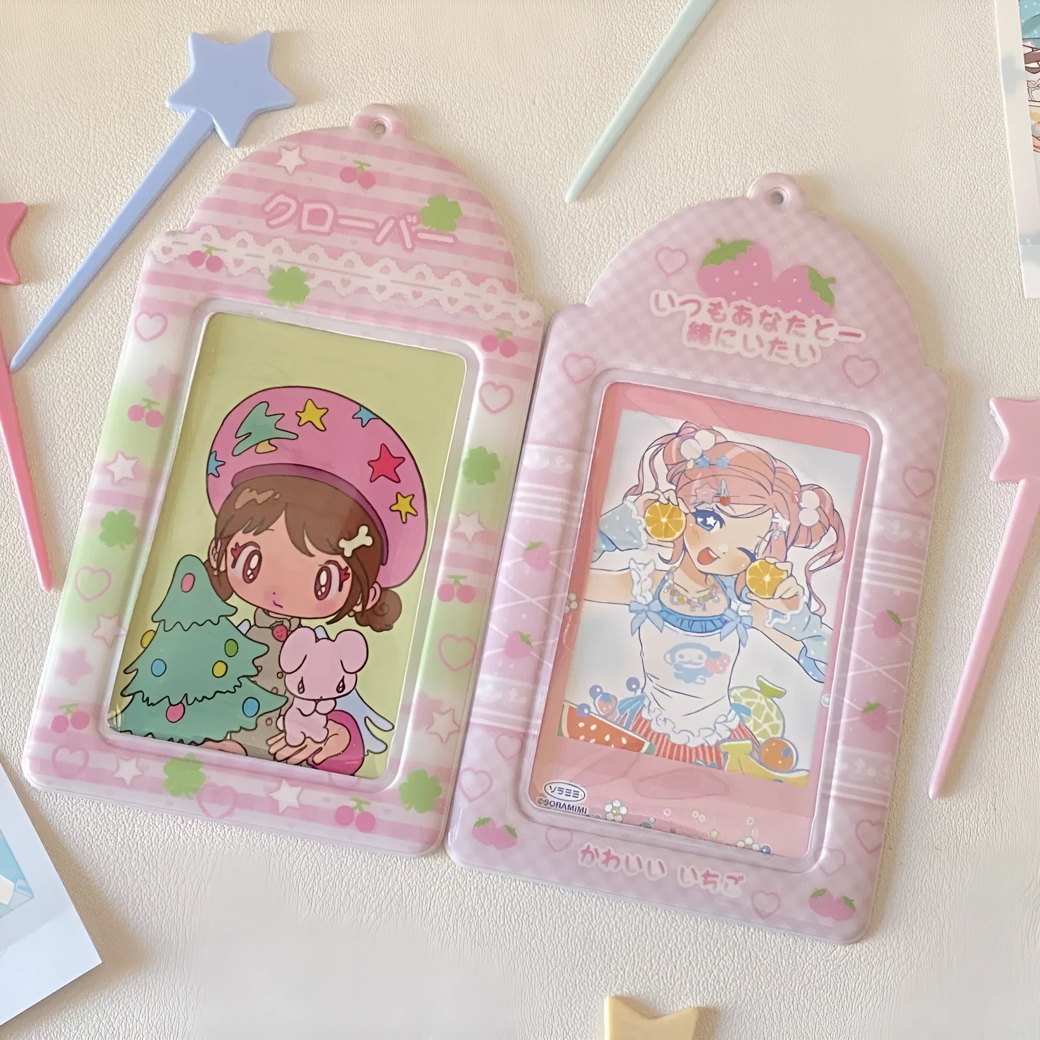 Transparent PVC card holder with cartoon strawberry or four-leaf clover design, measuring 7.6 by 13.6 cm.