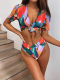 Red printed nylon split swimsuit for women, shown in a briefs-style bikini cut.