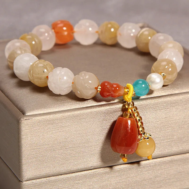 Women's yellow agate crystal bracelet on adjustable gold silk cord.