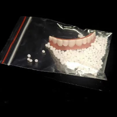 Disposable silicone simulation smile dentures with upper and lower teeth in colour box packaging