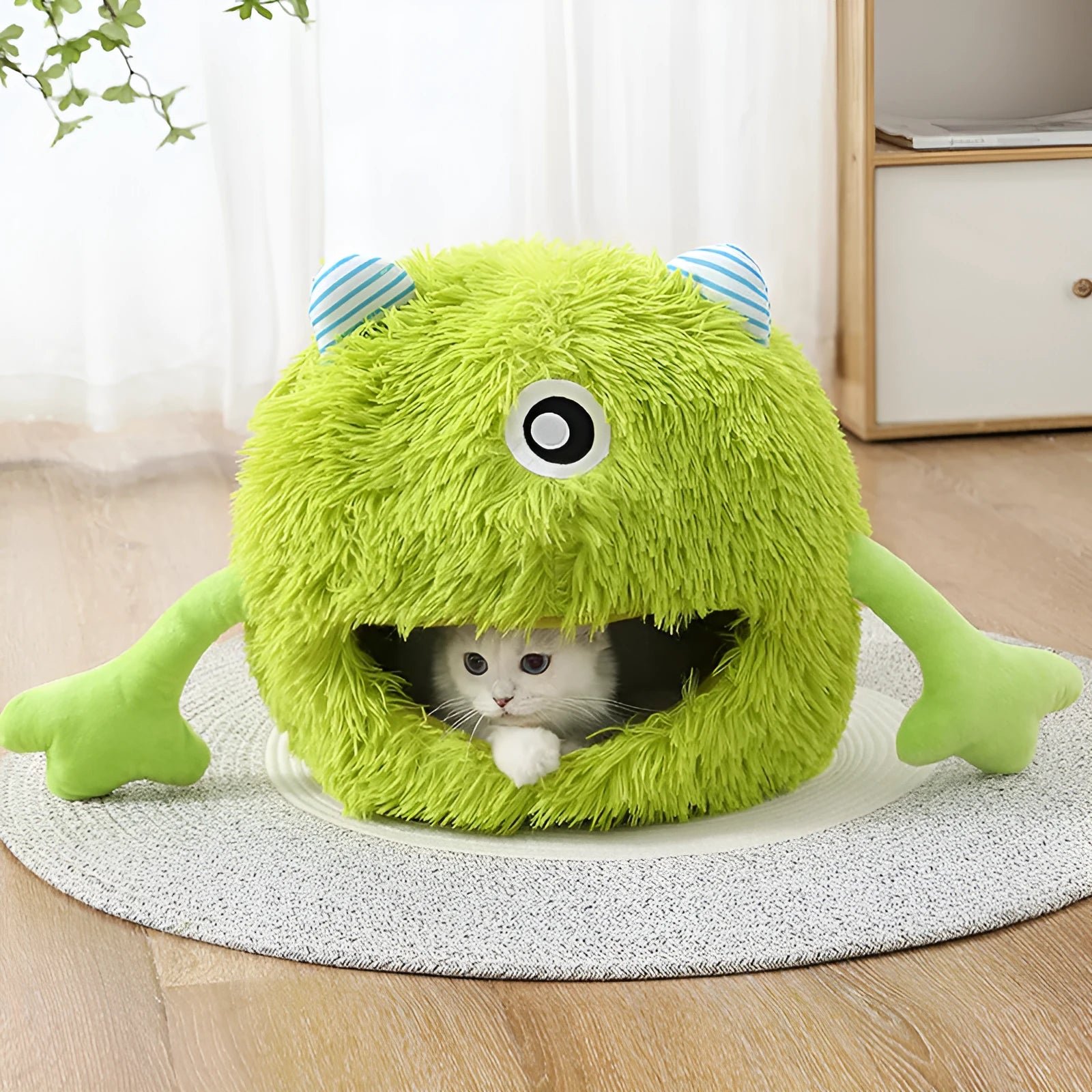 Fluffy round plush cat bed with a non-slip bottom, shown in grey.